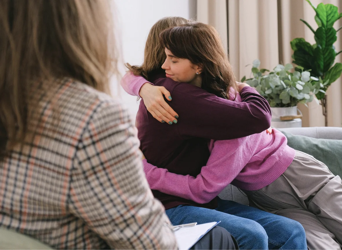 Two women embracing during a supportive group therapy session at Onward Counseling in Tempe AZ.